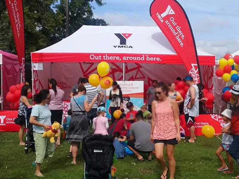 YMCA printed marquee image at an outdoor event