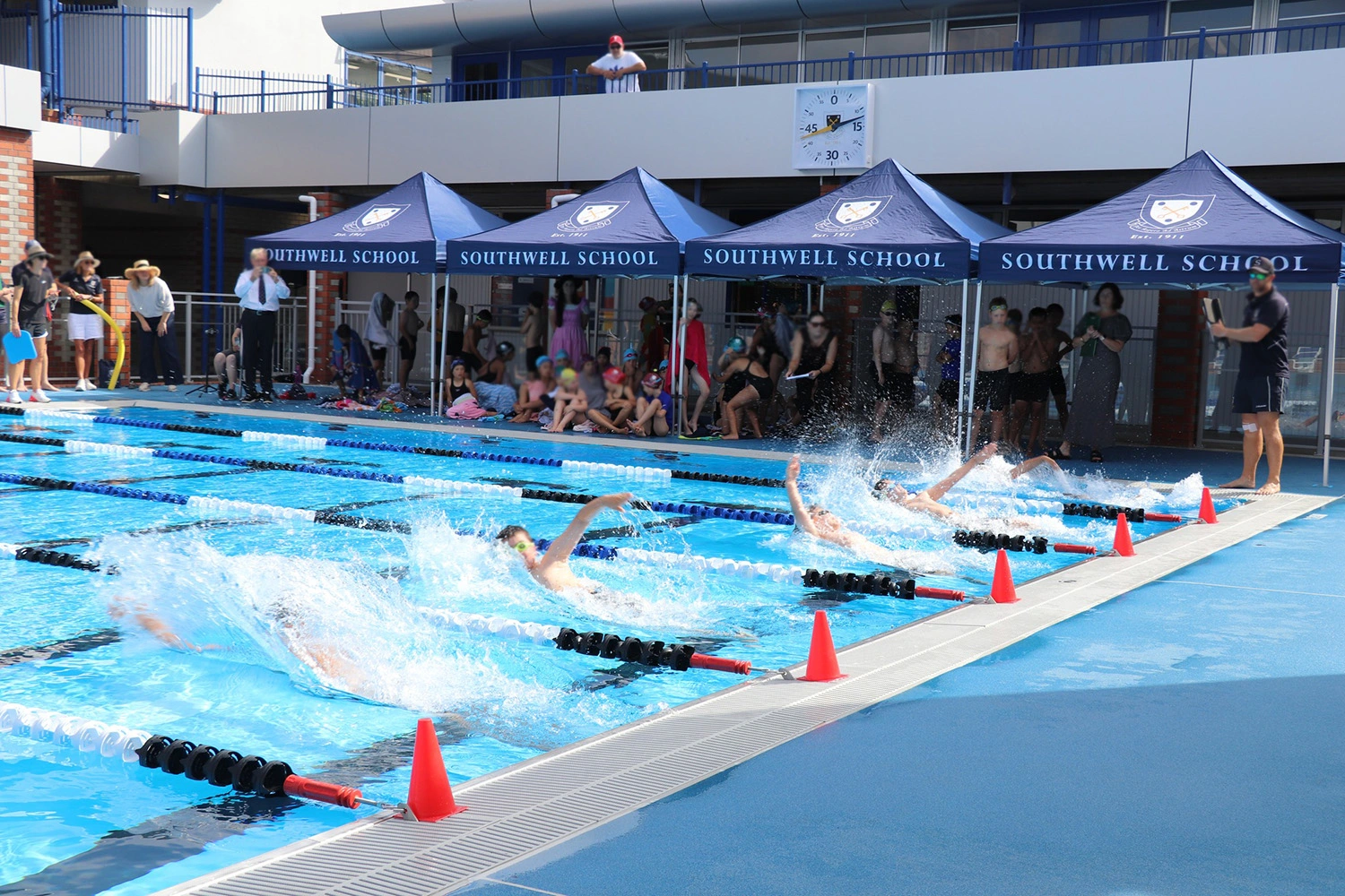 a group of 3x3m southwell school gazebo in navy for the open day