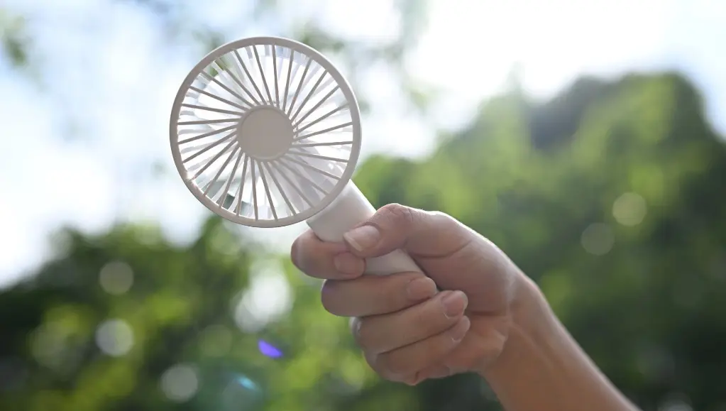 gazebo shade protection – person holding portable fan