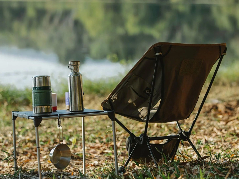 temporary camping supplies set up in a forest overlooking a lake